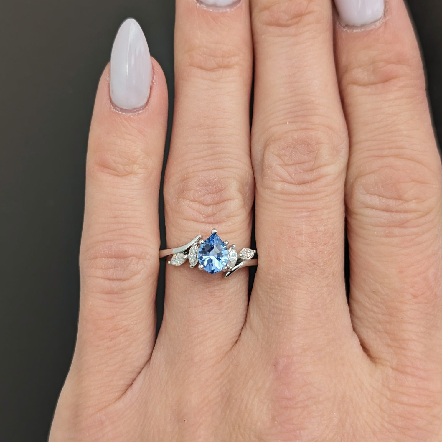 bypass ring with blue lab sapphire pear and moissanite