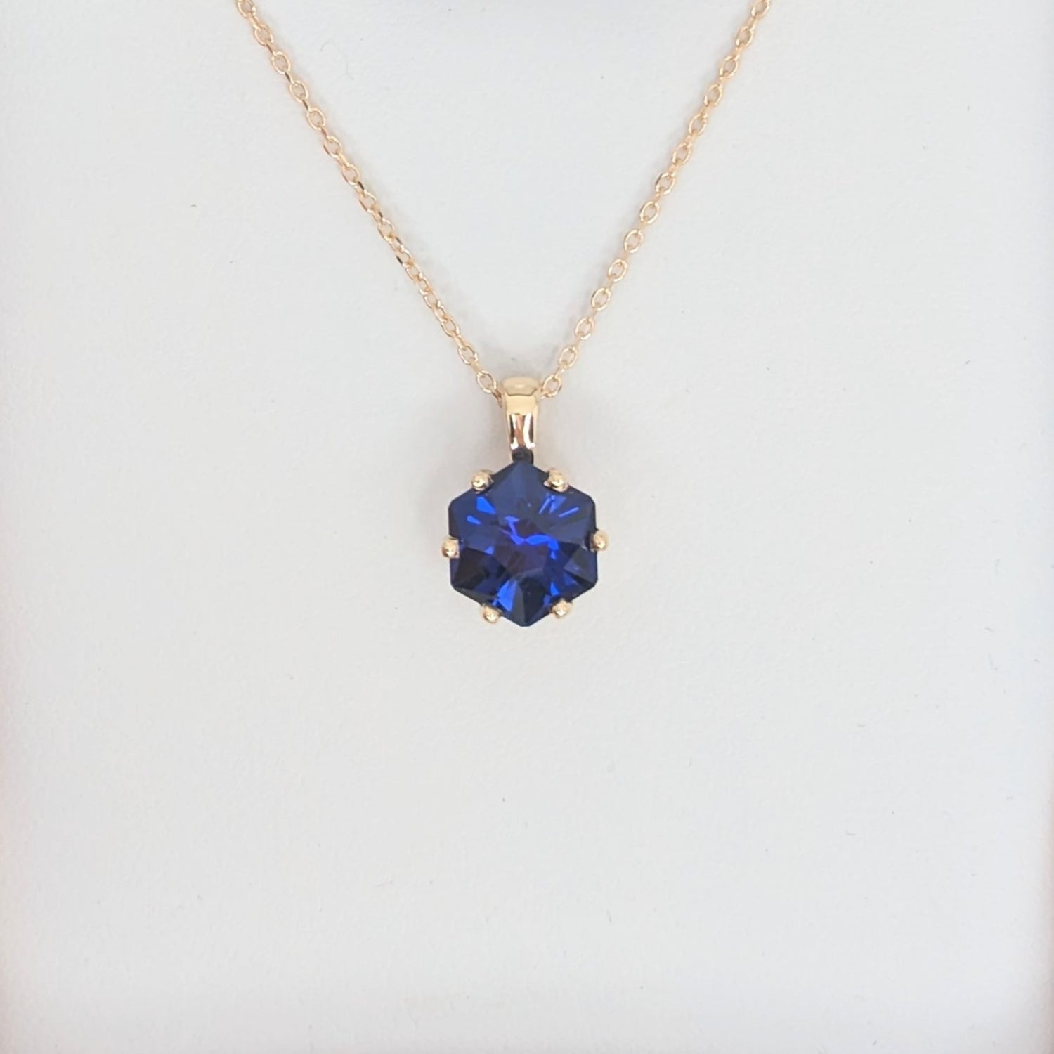 royal blue hex cut cosmos necklace in yellow gold