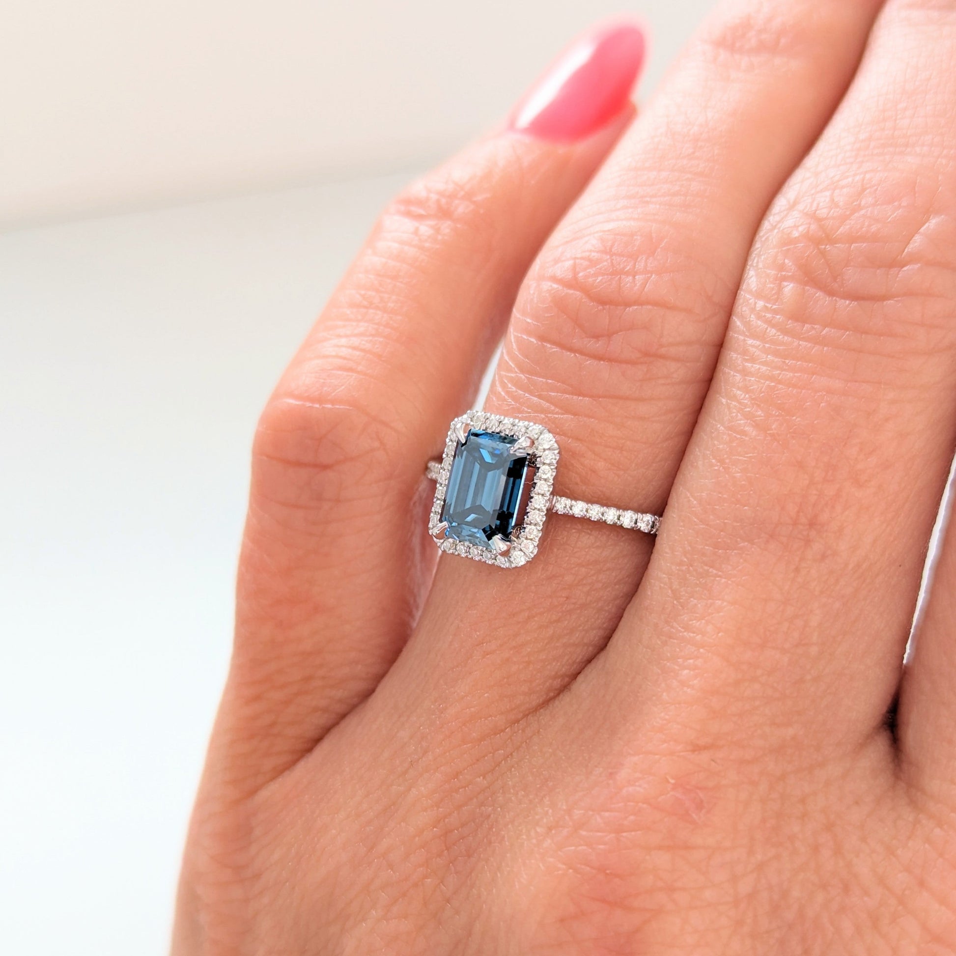 Cori engagement ring with emerald cut blue moissanite