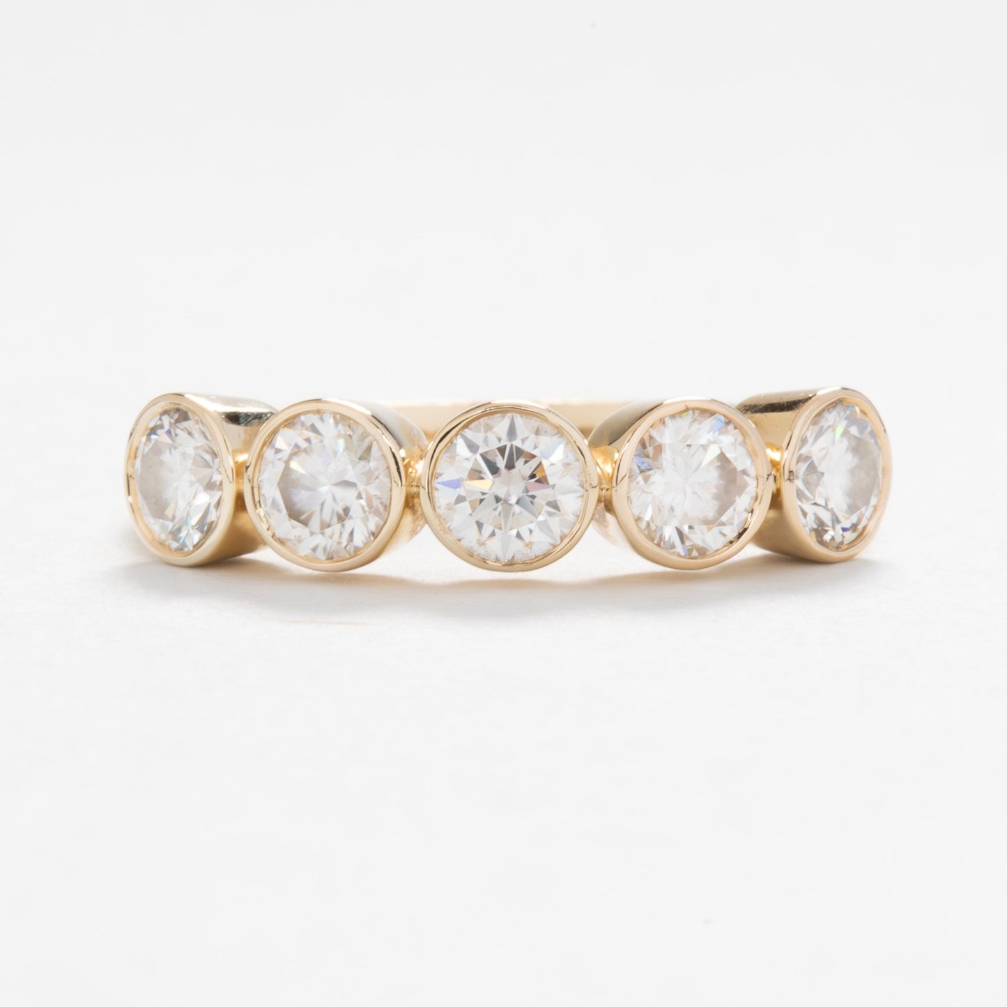 yellow gold band with round moissanites