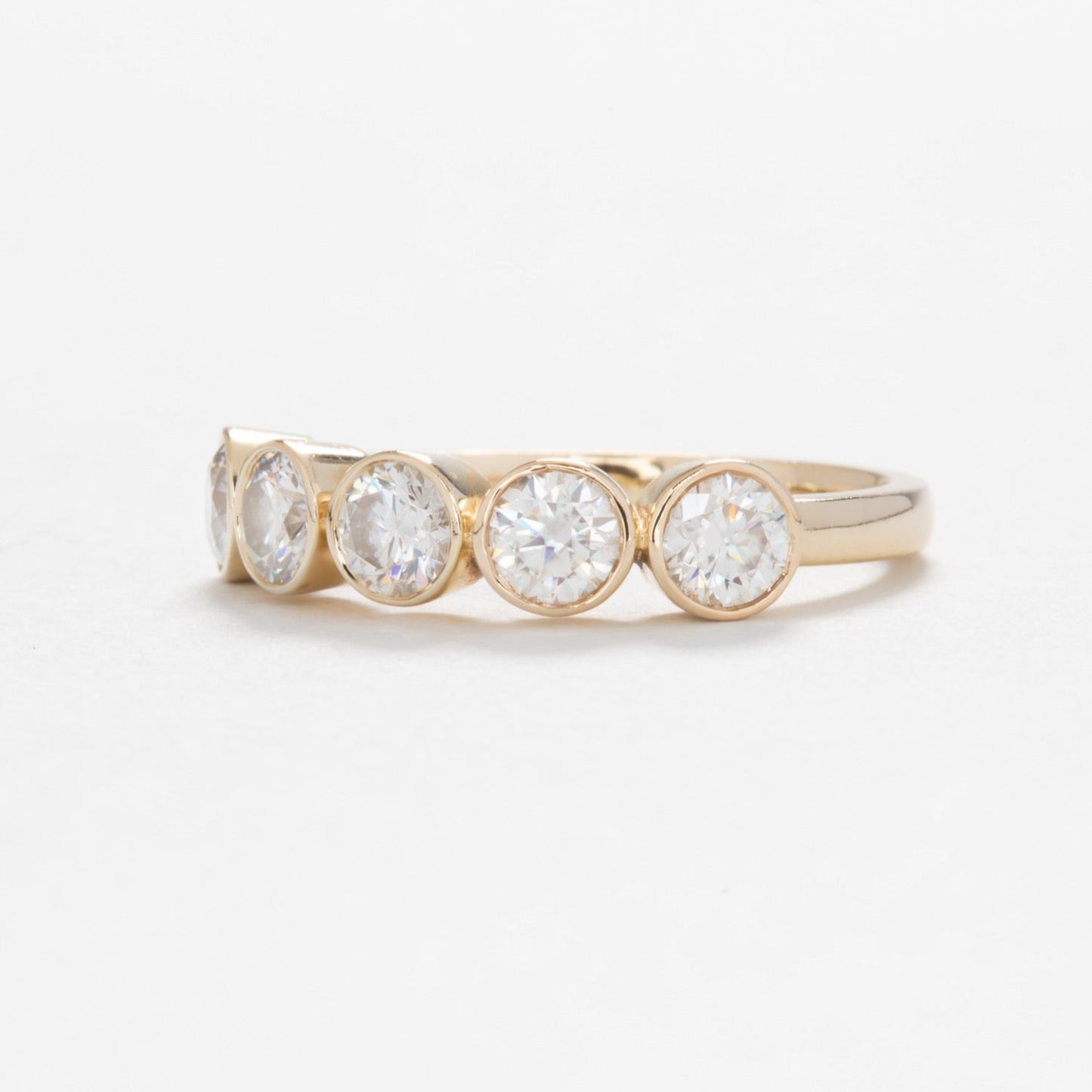 yellow gold band with round moissanites