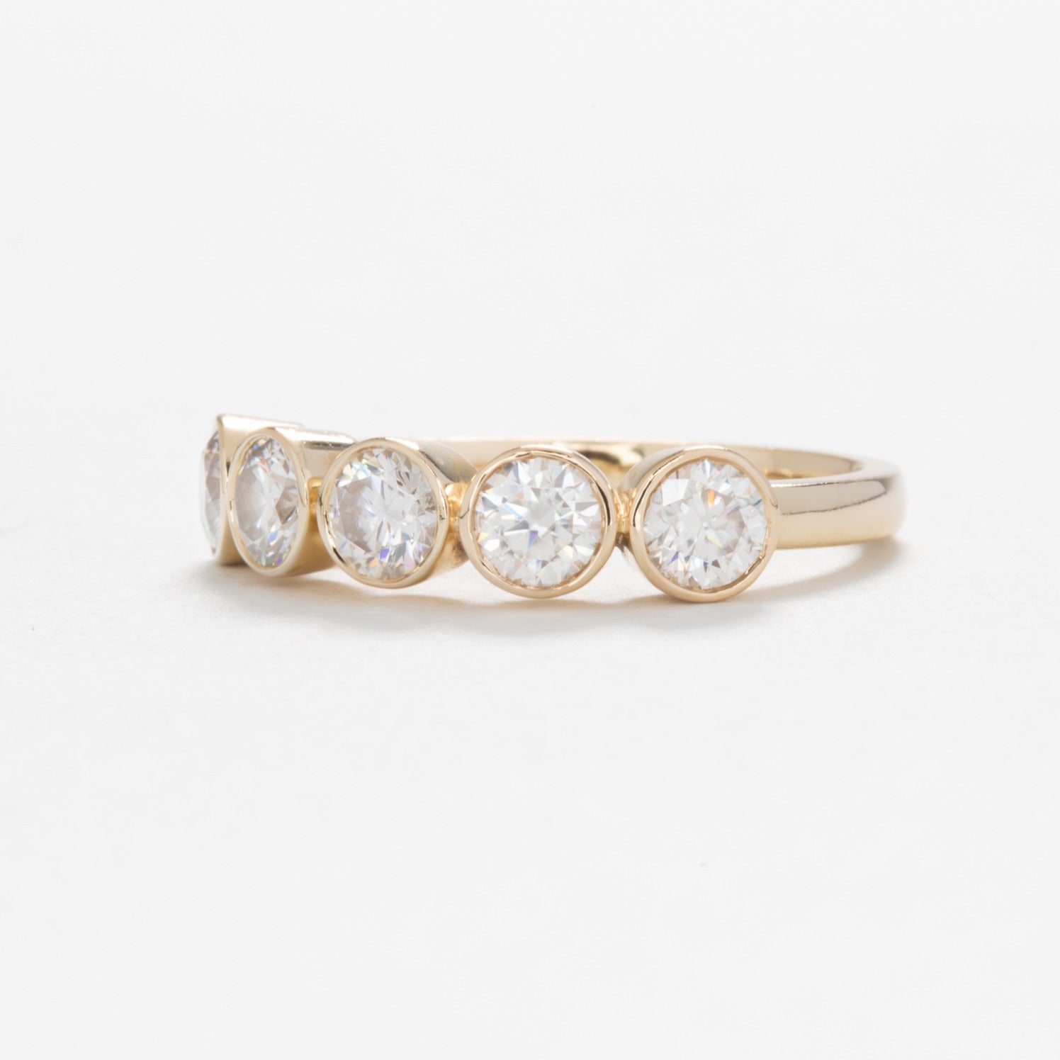 yellow gold band with round moissanites