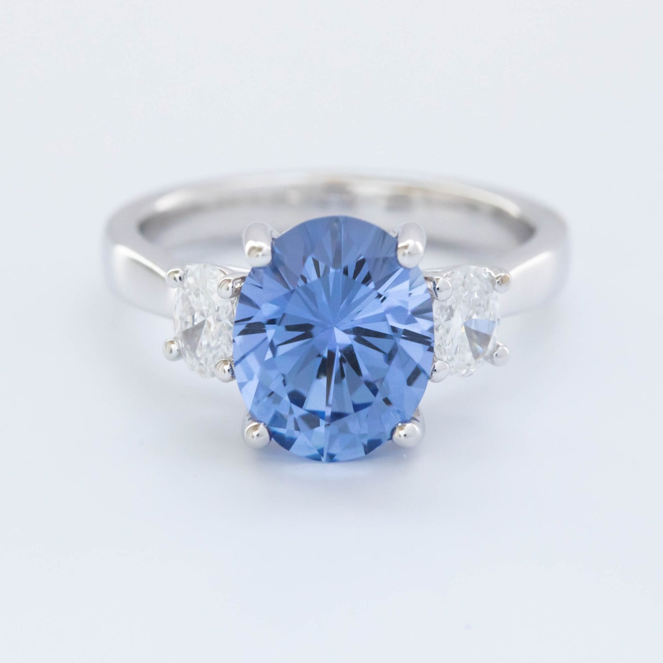 Milly three stone engagement ring with oval blue lab sapphire