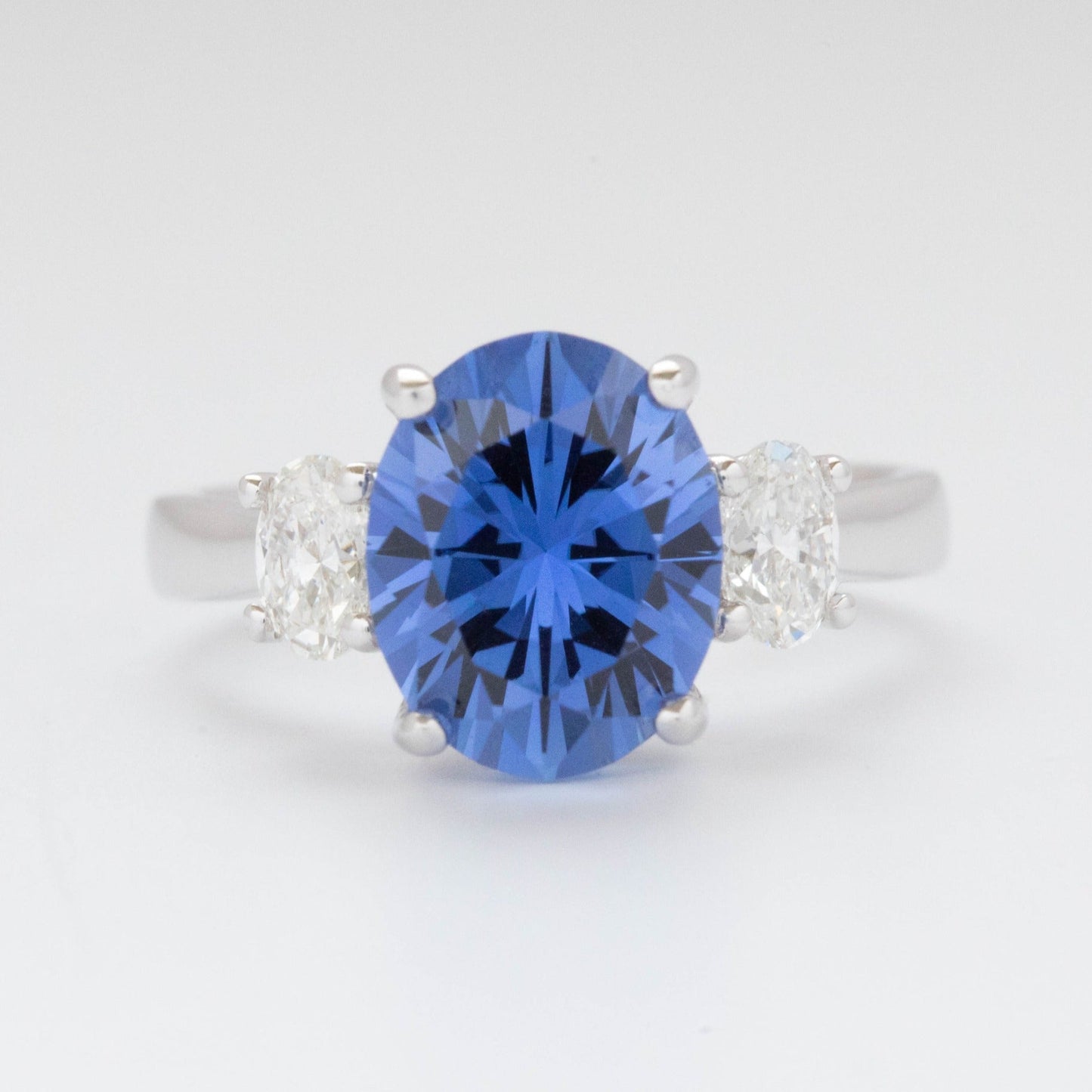 Milly three stone engagement ring with oval blue lab sapphire