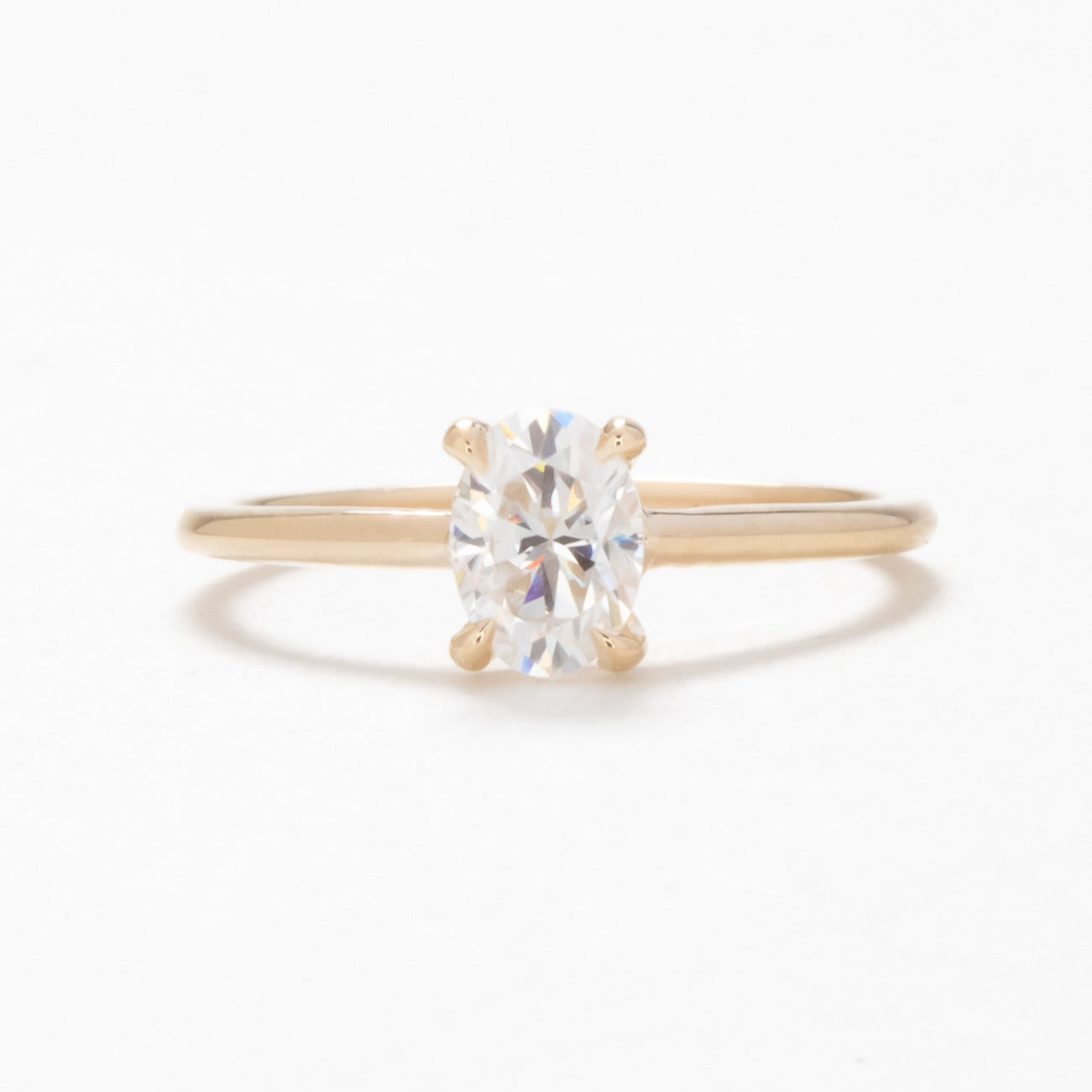 Petite oval solitaire engagement ring with moissanite 