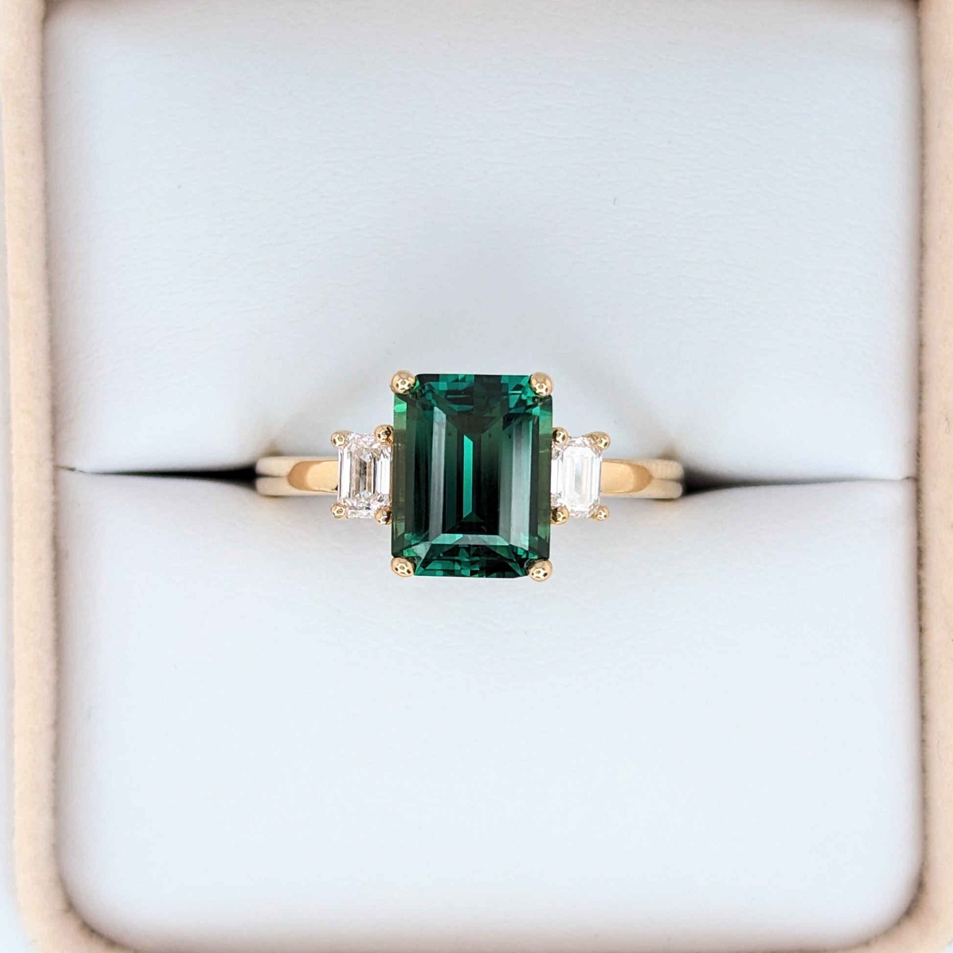 ami three stone engagement ring with green lab sapphire