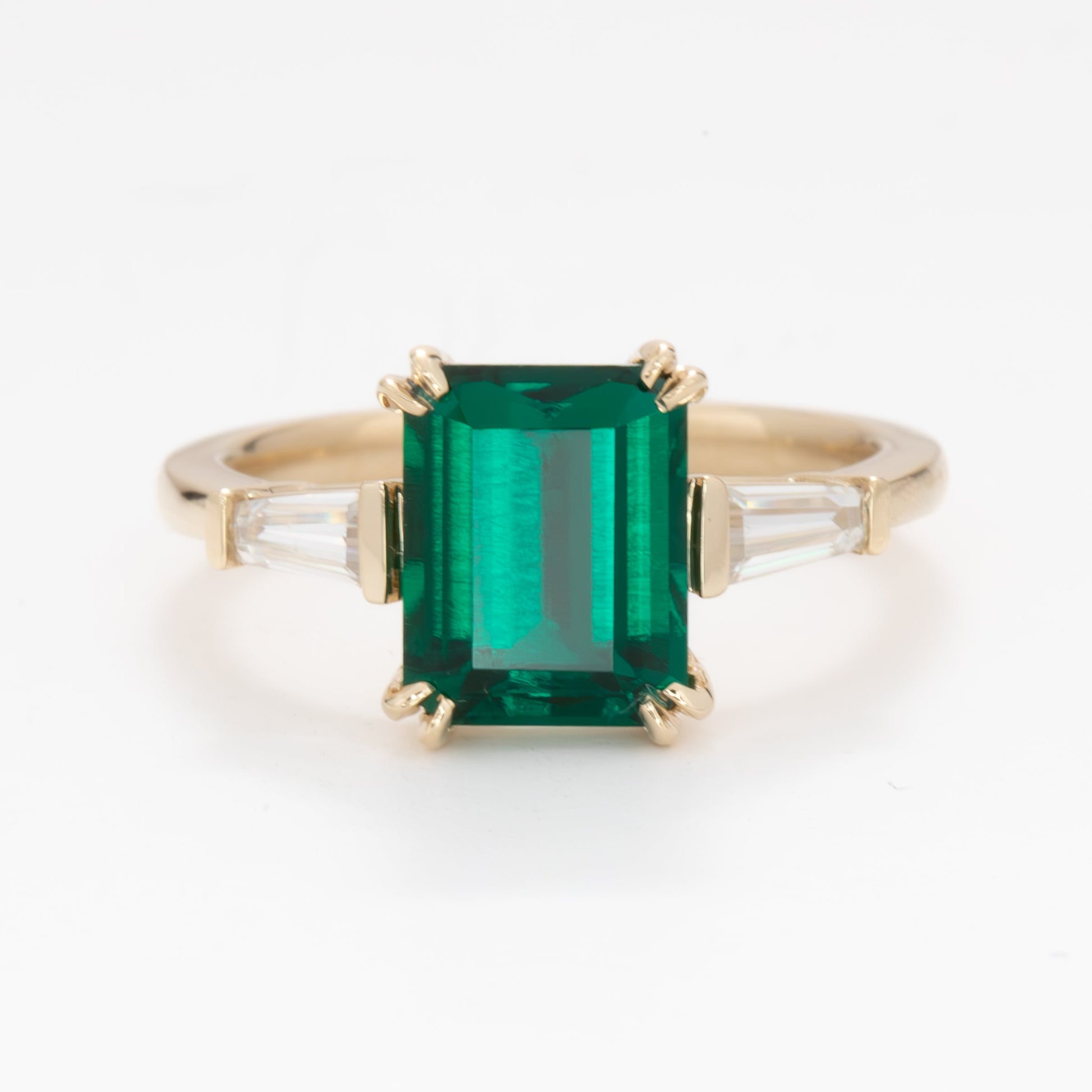 elyna three stone engagement ring with lab emerald