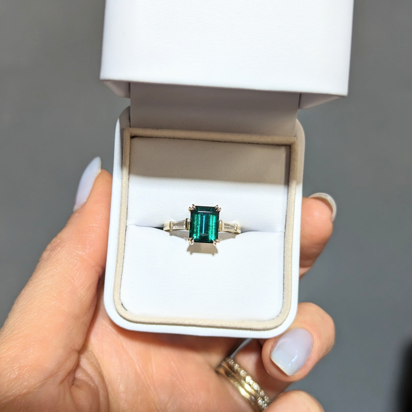 elyna three stone engagement ring with lab emerald