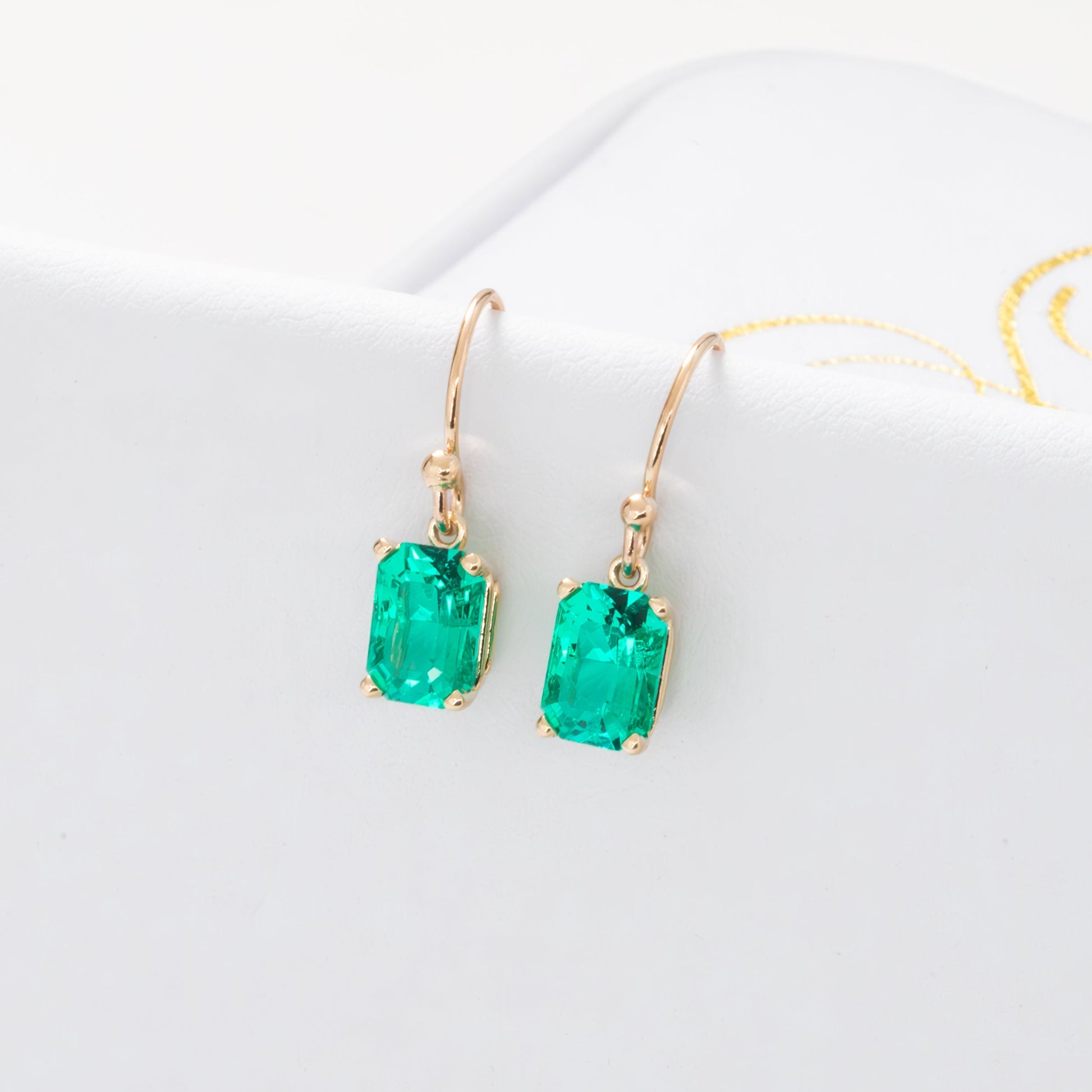 heather yellow gold drop earrings with radiant emeralds