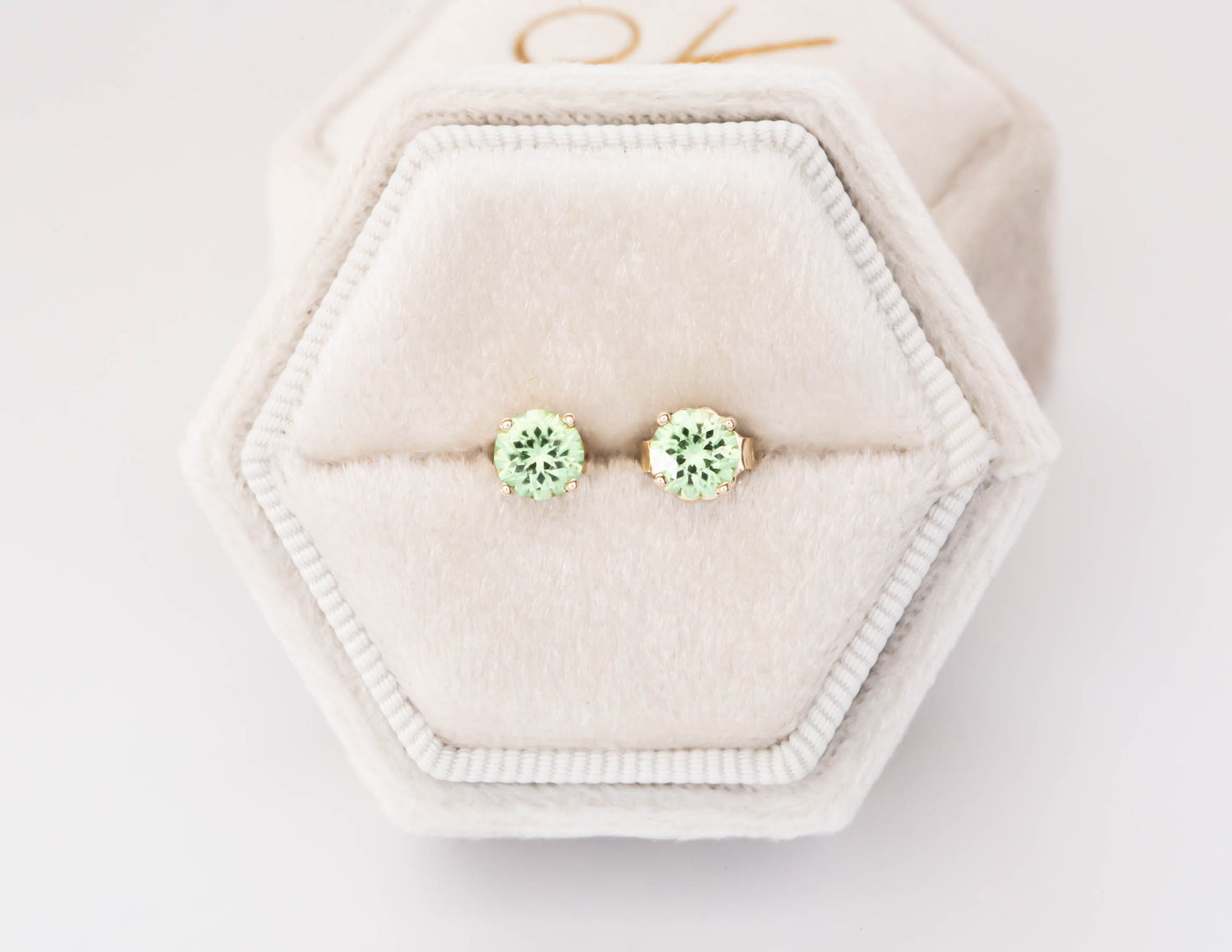 peridot stud earrings in yellow gold