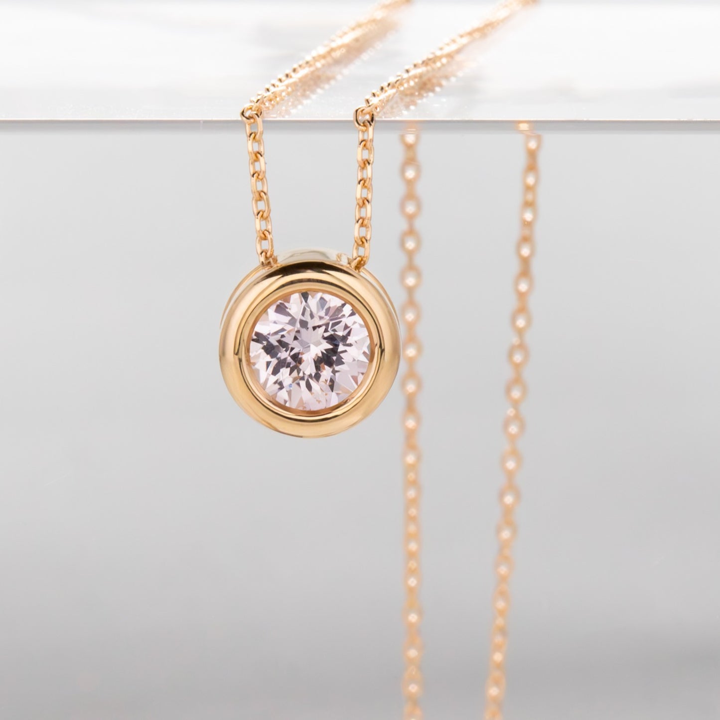 rhea necklace with pink lab sapphire in yellow gold