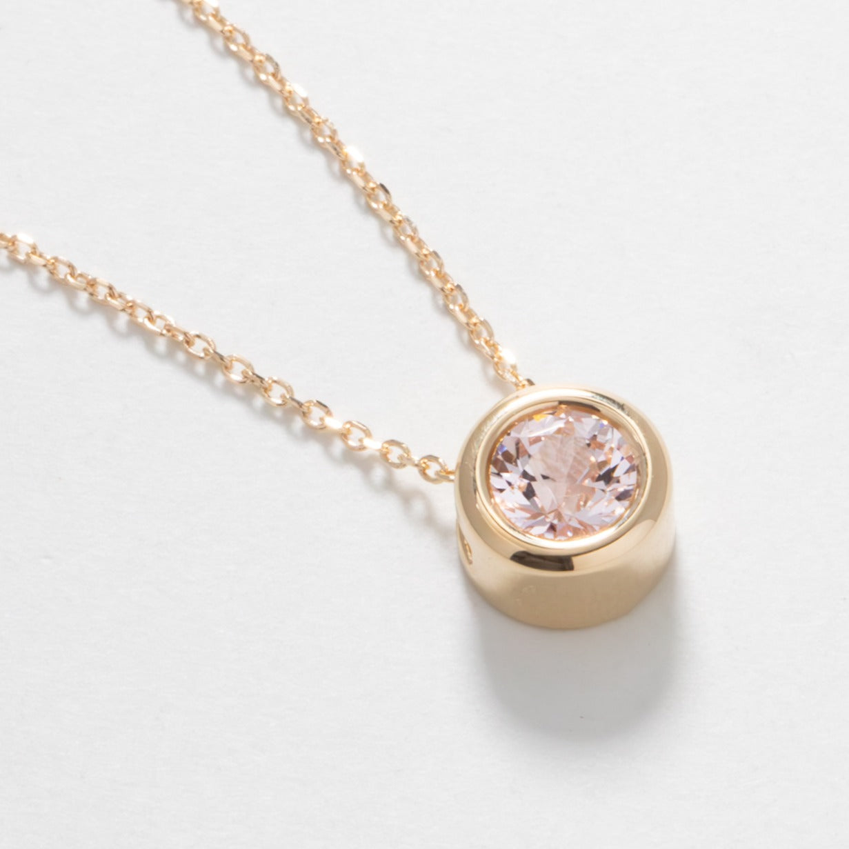 rhea necklace with pink lab sapphire in yellow gold