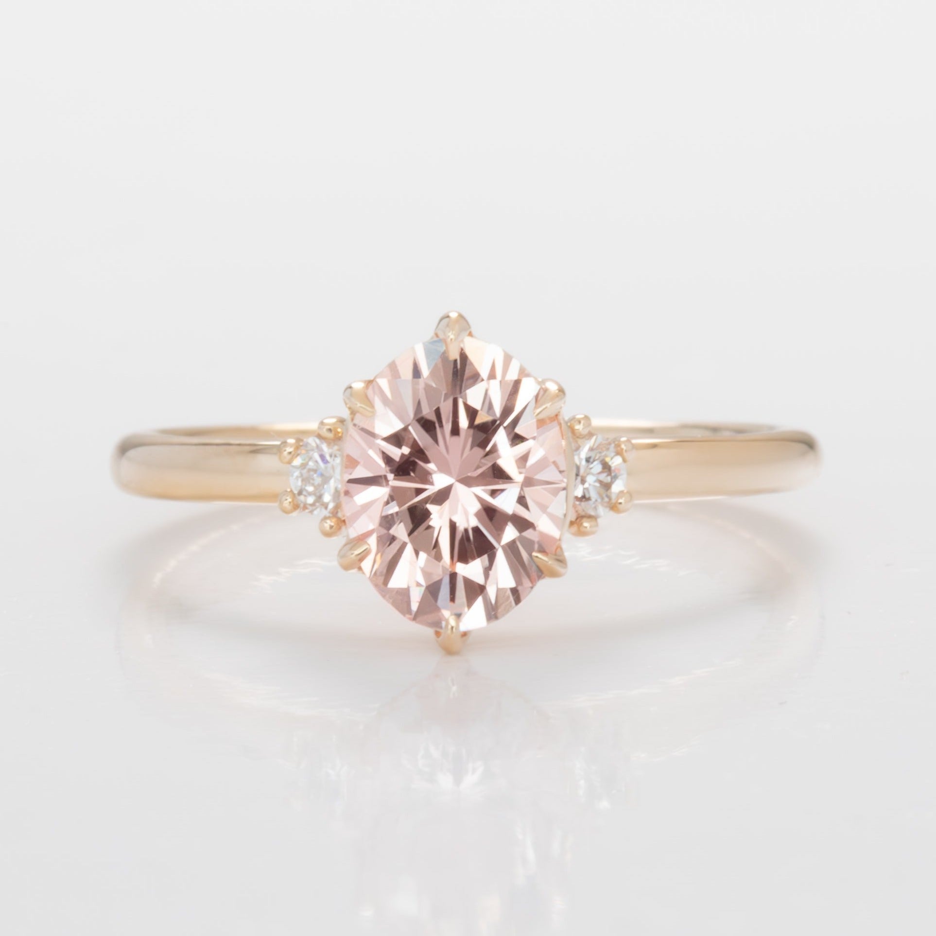 signy engagement ring with oval peach lab sapphire