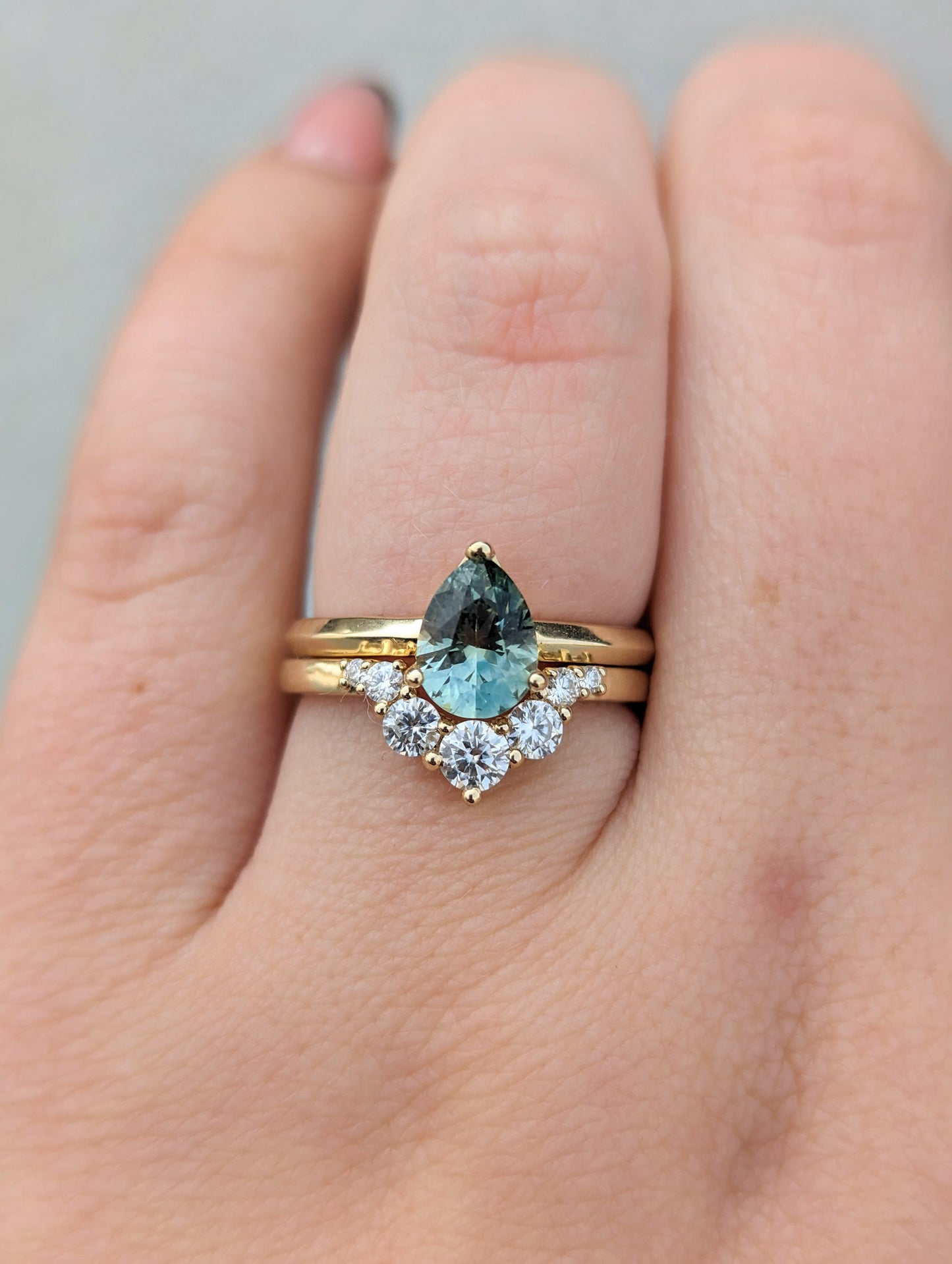 stella yellow gold wedding band with moissanite and montana sapphire