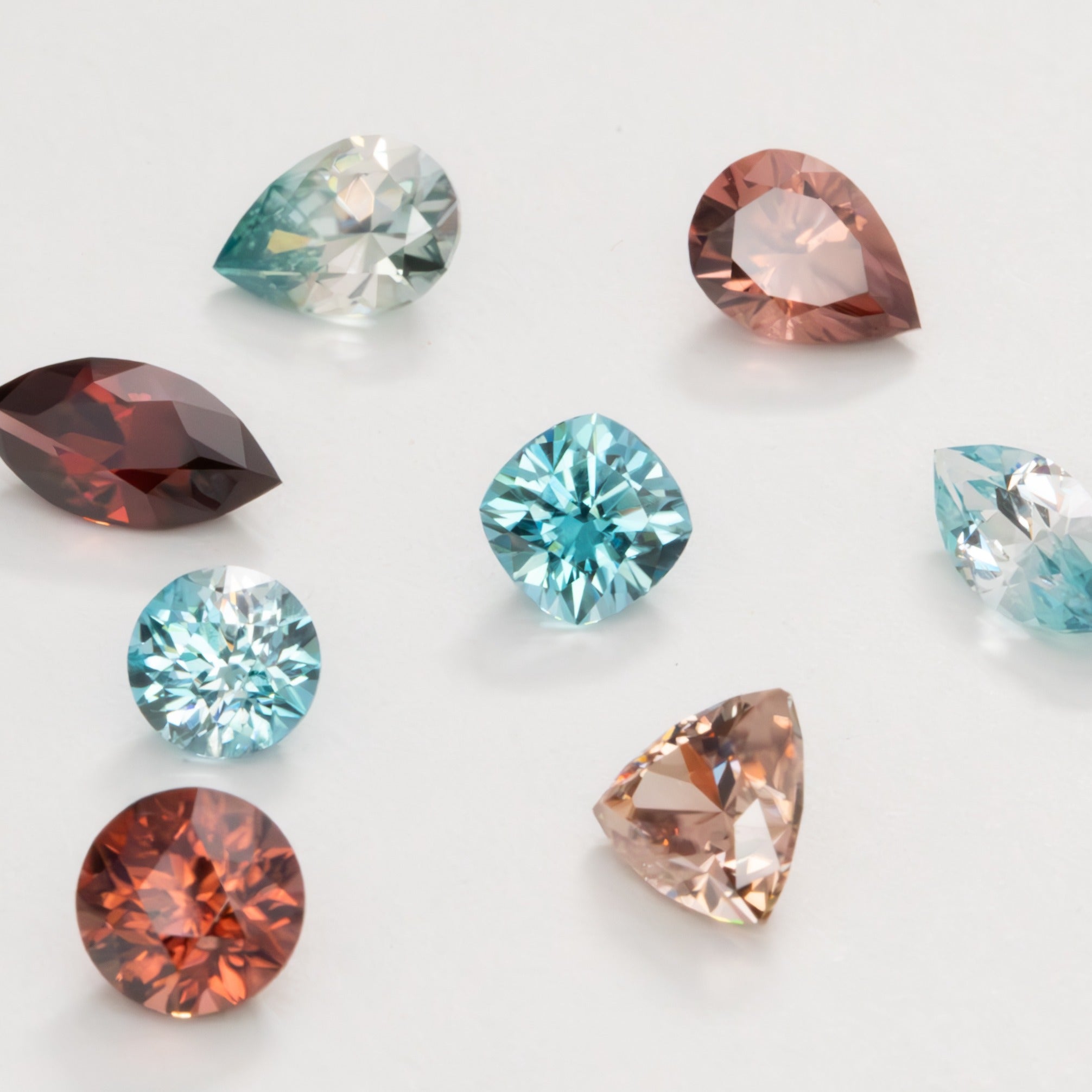 loose zircons in peach, red, orange, green and blue